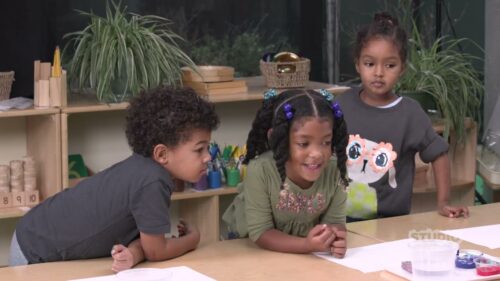 3 children at a shared desk