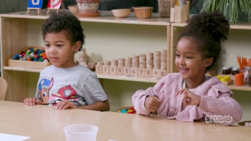 children sitting at shared desk