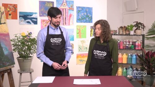 two art teachers with white paper in front of them on a table